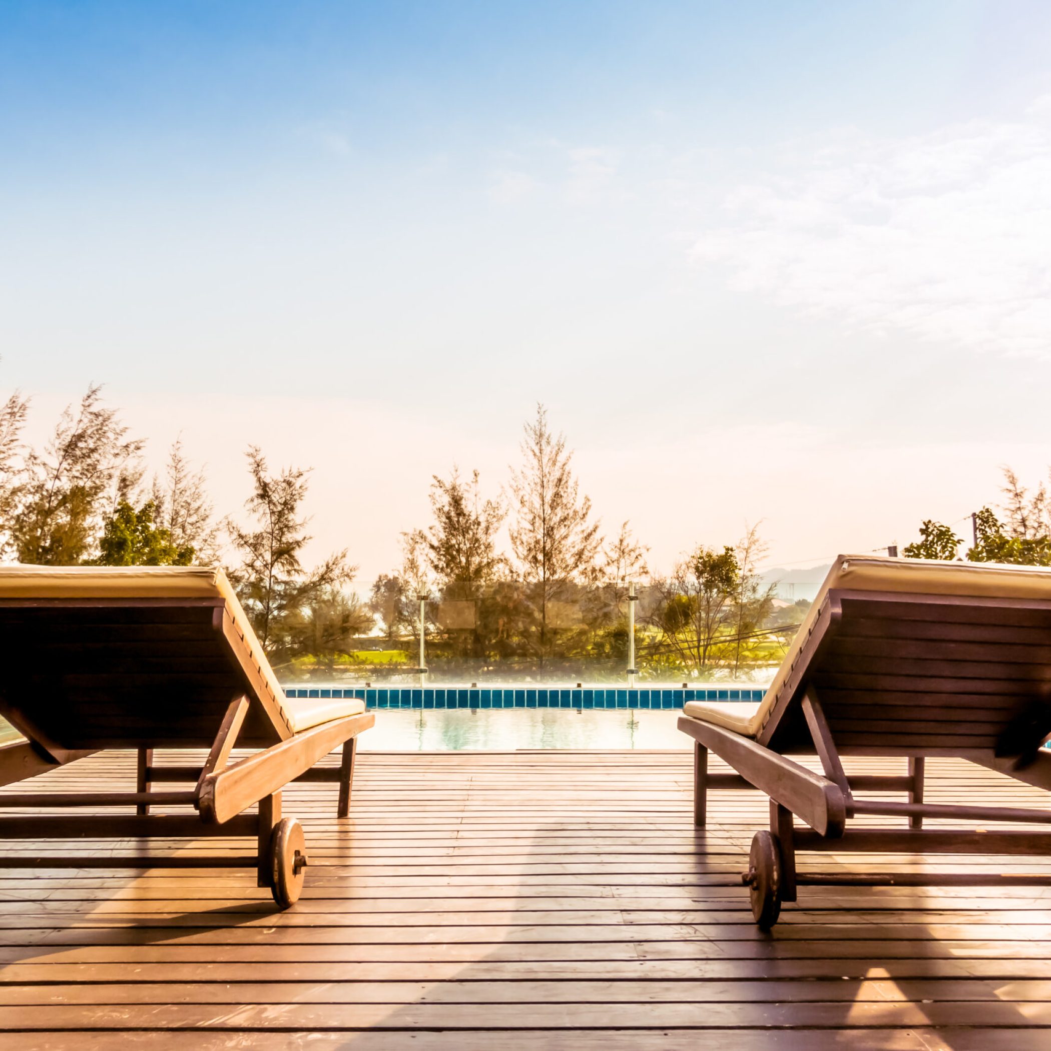 Empty chair and swimming pool at hotel resort - Vintage Filter